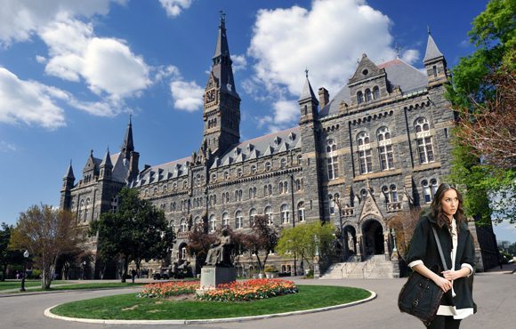 Washington, D.C., USA - April 9, 2012. Healy Hall with the statue of Georgetown University founder John Carroll in front and some people walking in background. Georgetown University is a top-ranking private university in the United States. It is located in the historic district of Georgetown in Northwest Washington, D.C.