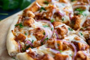 young adults love cooking BBQ chicken pizza